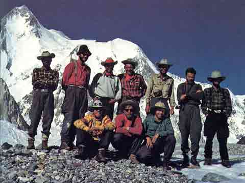 
The expedition poses in front of Gasherbrum I (Hidden Peak) at Base Camp after the first ascent in 1958.
Behind the team is Gasherbrum I (Hidden Peak) above the Abrruzzi Glacier. The summit on the left, Hidden South in the middle, and the Roch ridge used by the expedition on the far right.
Front, left to right: Bob Swift, Tom Nevison, Dick Irvin. Rear: Mohd Akram, Gil Roberts, Ras Rizvi, Pete Schoening, Nick Clinch, Andy Kauffman, Tom McCormack. - A Walk In The Sky book
- A Walk In The Sky book
